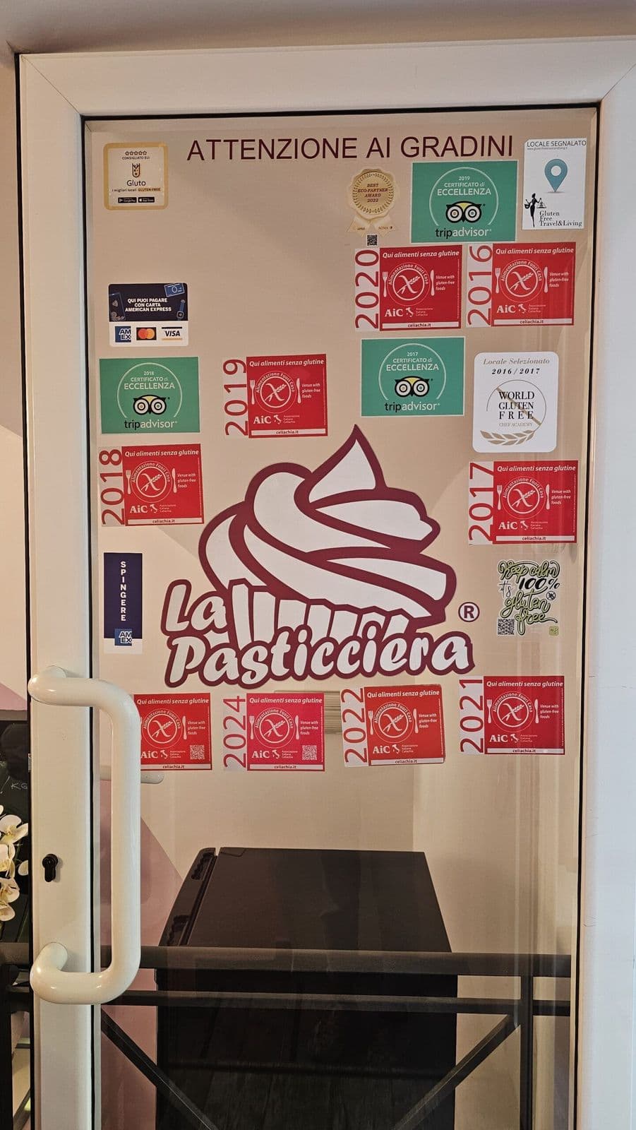 Gluten-free bakery door in Rome covered with AIC celiac certification stickers