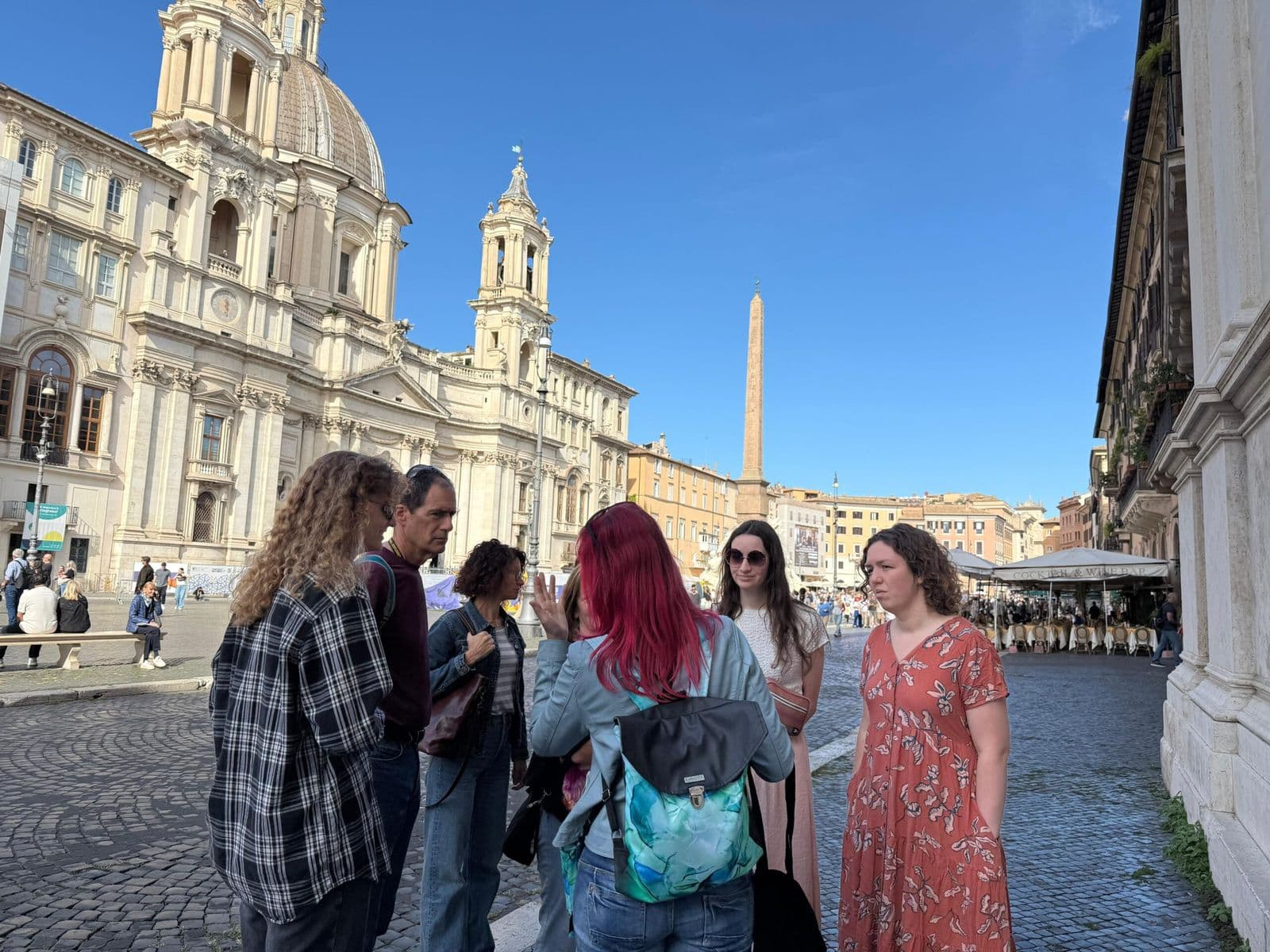 A small group on a gluten-free orientation walk in a Roman square