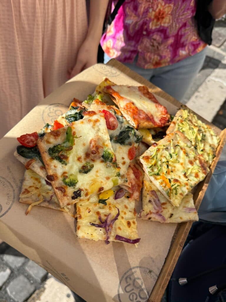 A tray of gluten-free Roman pizza al taglio with vegetables and cheese