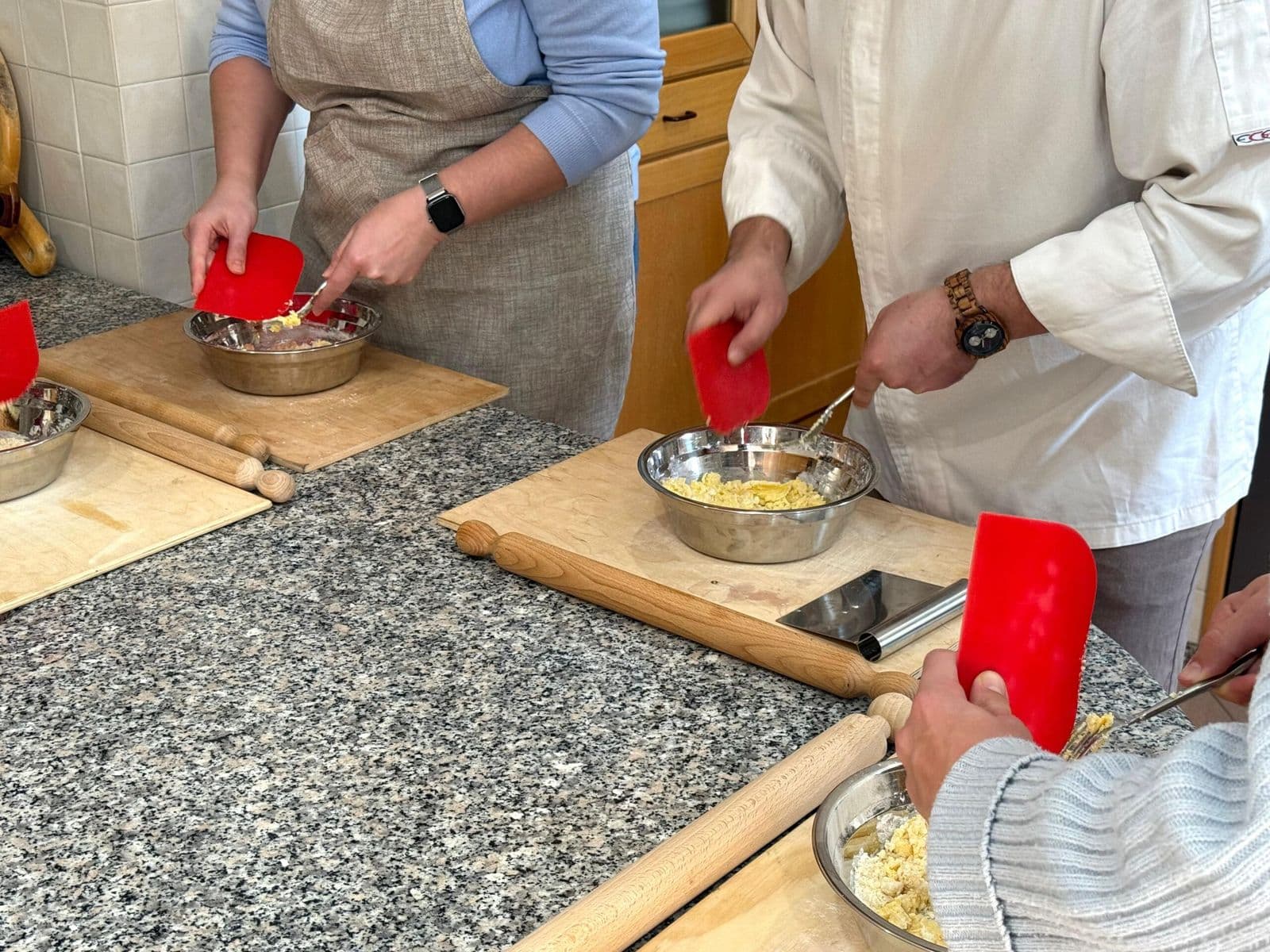 Guests and a chef preparing gluten-free dough in a Rome cooking class