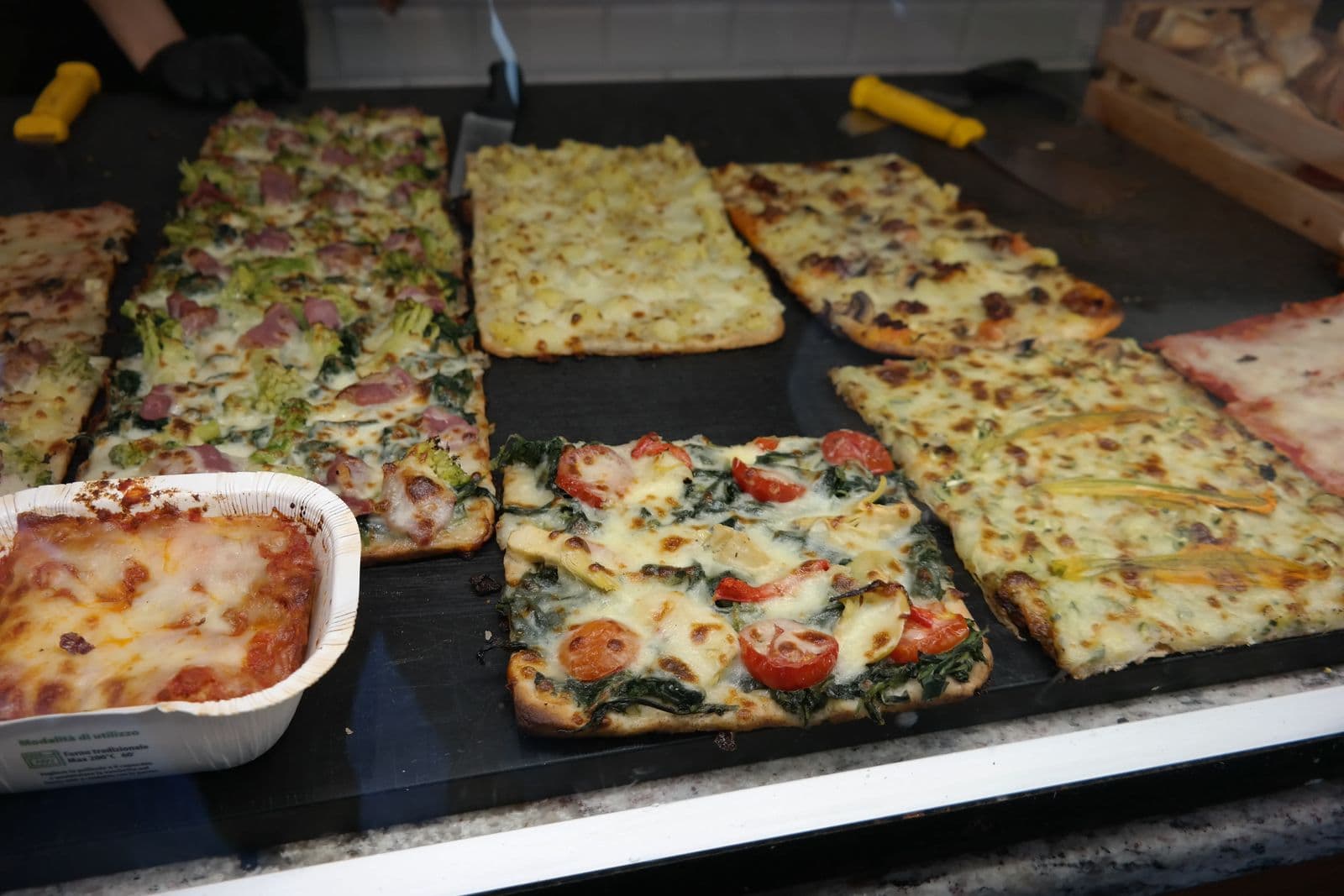 Gluten-free pizza al taglio at a stop on a celiac-safe Rome food tour