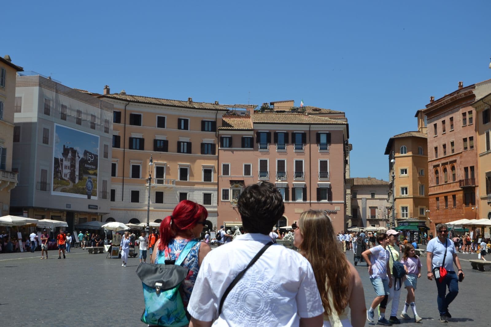 Travelers crossing a sunny Roman square on a gluten-free food tour